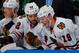 BUFFALO, NY - MARCH 09: Jonathan Toews #19 of the Chicago Blackhawks winces in pain alongside Brandon Bollig #52 on the bench after being slashed on the arm in the third period against the Buffalo Sabres on March 9, 2014 at the First Niagara Center in Buffalo, New York. Toews returned to action and Chicago won, 2-1. (Photo by Bill Wippert/NHLI via Getty Images)