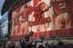 Fans gather around the statue of former Arsenal player Dennis Bergkamp, in front of the Emirates Stadium, in London, Saturday, Feb. 22, 2014. (AP Photo/Bogdan Maran)