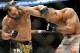 Johny Hendricks, left, and Robbie Lawler exchange punches during a UFC 171 mixed martial arts welterweight title bout, Saturday, March 15, 2014, in Dallas. Hendricks won by decision. (AP Photo/Matt Strasen)