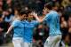 HULL, ENGLAND - MARCH 15: Edin Dzeko (R) of Manchester City celebrates his goal with team mates Jesus Navas (L) and David Silva during the Barclays Premier League match between Hull City and Manchester City at the KC Stadium on March 15, 2014 in Hull, England. (Photo by Paul Thomas/Getty Images)