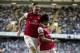 Arsenal's Tomas Rosicky, right, celebrates scoring with teammate Olivier Giroud during the English Premier League soccer match between Tottenham Hotspur and Arsenal at White Hart Lane stadium in London, Sunday, March 16, 2014. (AP Photo/Matt Dunham)