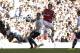 Arsenal's Tomas Rosicky, right, scores past Tottenham Hotspur's Jan Vertonghen during the English Premier League soccer match between Tottenham Hotspur and Arsenal at White Hart Lane stadium in London, Sunday, March 16, 2014. (AP Photo/Matt Dunham)
