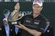 John Senden, of Australia, holds up the trophy after winning the Valspar Championship golf tournament at Innisbrook, Sunday, March 16, 2014, in Palm Harbor, Fla. (AP Photo/Chris O'Meara)