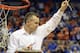 Florida coach Billy Donovan holds up a piece of the net after the Gators became the first team in Southeastern Conference history to go 18-0 in league pla, Saturday, March 8, 2014 in Gainesville, Fla. Florida defeated Kentucky 84-65 Saturday in an NCAA college basketball game. (AP Photo/Phil Sandlin)