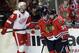 Chicago Blackhawks' Jonathan Toews (19) celebrates with Michal Rozsival (32) after scoring his goal as Detroit Red Wings' Niklas Kronwall (55) reacts during the third period of an NHL hockey game in Chicago, Sunday, March 16, 2014. The Blackhawks won 4-1. (AP Photo/Nam Y. Huh)