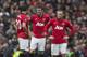 Manchester United's Wayne Rooney, right, Michael Carrick, centre, and Robin van Persie wait for play to restart after Liverpool's first goal during their English Premier League soccer match at Old Trafford Stadium, Manchester, England, Sunday March 16, 2014. Liverpool won the game 3-0. (AP Photo/Jon Super)