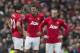 Manchester United's Wayne Rooney, right, Michael Carrick, centre, and Robin van Persie wait for play to restart after Liverpool's first goal during their English Premier League soccer match at Old Trafford Stadium, Manchester, England, Sunday March 16, 2014. Liverpool won the game 3-0. (AP Photo/Jon Super)