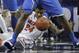 Florida forward Casey Prather (24) reaches for a loose ball in between the legs of Kentucky forward Alex Poythress (22) during the second half of an NCAA college basketball game in the Championship round of the Southeastern Conference men's tournament, Sunday, March 16, 2014, in Atlanta. (AP Photo/Steve Helber)