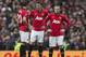 Manchester United's Wayne Rooney, right, Michael Carrick, centre, and Robin van Persie wait for play to restart after Liverpool's first goal during their English Premier League soccer match at Old Trafford Stadium, Manchester, England, Sunday March 16, 2014. Liverpool won the game 3-0. (AP Photo/Jon Super)