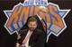 New York Knicks new team president Phil Jackson puts his hand on team owner James Dolan, seated, during a news conference where Jackson was introduced, at New York's Madison Square Garden, Tuesday, March 18, 2014. Jackson signed a five-year contract that will reportedly pay him at least $12 million annually and said he will spend significant time in New York. (AP Photo/Richard Drew)