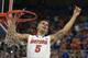 Florida guard Scottie Wilbekin (5) holds up a piece of the net after the Gators became the first team in Southeastern Conference history to go 18-0 in league pla, Saturday, March 8, 2014 in Gainesville, Fla. Florida defeated Kentucky 84-65 Saturday in an NCAA college basketball game. (AP Photo/Phil Sandlin)