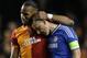 Galatasaray's Didier Drogba, left, embraces Chelsea's John Terry at the end of the Champions League round of 16 second leg soccer match between Chelsea and Galatasaray at Stamford Bridge stadium in London Tuesday, March 18, 2014. (AP Photo/Kirsty Wigglesworth)