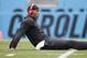 Carolina Panthers' Cam Newton stretches before an NFL football game against the New Orleans Saints in Charlotte, N.C., Sunday, Dec. 22, 2013. (AP Photo/Bob Leverone)