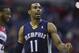 Memphis Grizzlies point guard Mike Conley (11) shouts to teammates during the second half of an NBA basketball game against the Washington Wizards on Monday, March 3, 2014, in Washington. (AP Photo/ Evan Vucci)