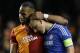 Galatasaray's Didier Drogba, left, embraces Chelsea's John Terry at the end of the Champions League round of 16 second leg soccer match between Chelsea and Galatasaray at Stamford Bridge stadium in London Tuesday, March 18, 2014. (AP Photo/Kirsty Wigglesworth)
