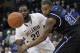 Villanova's JayVaughn Pinkston (22) passes the ball around Seton Hall's Eugene Teague (21) during the first half of an NCAA college basketball game, Friday, Feb. 7, 2014, in Villanova, Pa. (AP Photo/Laurence Kesterson)