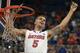 Florida guard Scottie Wilbekin (5) holds up a piece of the net after the Gators became the first team in Southeastern Conference history to go 18-0 in league pla, Saturday, March 8, 2014 in Gainesville, Fla. Florida defeated Kentucky 84-65 Saturday in an NCAA college basketball game. (AP Photo/Phil Sandlin)
