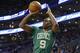 Boston Celtics guard Rajon Rondo shoots against the Phoenix Suns during the first quarter of an NBA basketball game in Boston Friday, March 14, 2014. (AP Photo/Winslow Townson)