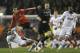 Benfica's Lazae Markovic leaps into the air as he vies for the ball with Tottenham's Sandro, right, during the Europa League round of 16 first leg soccer match between Tottenham Hotspur and SL Benfica at White Hart Lane stadium in London Thursday, March 13, 2014. (AP Photo/Kirsty Wigglesworth)