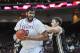 Mar 15, 2014; Las Vegas, NV, USA; New Mexico State Aggies player Sim Bhullar (2) protects the ball against the defense of Idaho Vandals player Joe Kammerer (42) in the championship game for the WAC Conference college basketball tournament at Orleans Arena. Mandatory Credit: Stephen R. Sylvanie-USA TODAY Sports