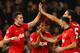 MANCHESTER, ENGLAND - MARCH 19: Robin van Persie of Manchester United celebrates scoring the second goal with his team-mates during the UEFA Champions League Round of 16 second round match between Manchester United and Olympiacos FC at Old Trafford on March 19, 2014 in Manchester, England. (Photo by Laurence Griffiths/Getty Images)