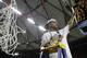 Florida guard Scottie Wilbekin shows a part of the net after the second half of an NCAA college basketball game against Kentucky in the Championship round of the Southeastern Conference men's tournament, Sunday, March 16, 2014, in Atlanta. Florida won 61-60.(AP Photo/Steve Helber)