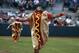 The winner of the hot dog race crosses the finish line in a spring exhibition baseball game between the Houston Astros and the Atlanta Braves, Sunday, March 2, 2014, in Kissimmee, Fla. The Astros won 7-4. (AP Photo/Alex Brandon)