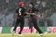 Hong Kong's bowler Nizakat Khan, right and Ehsan Nawaz celebrate the dismissal of Bangladesh's Abdur Razzak during their ICC Twenty20 Cricket World Cup match in Chittagong, Bangladesh, Thursday, March 20, 2014 . (AP Photo/Bikas Das)