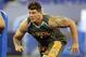 Michigan offensive lineman Taylor Lewan runs a drill at the NFL football scouting combine in Indianapolis, Saturday, Feb. 22, 2014. (AP Photo/Michael Conroy)