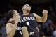 Harvard's Siyani Chambers, right, leaps into the arms of teammate Brandyn Curry after the team beat Cincinnati in the second round of the NCAA college basketball tournament in Spokane, Wash., Thursday, March 20, 2014. Harvard won 61-57. (AP Photo/Elaine Thompson)
