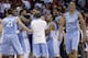 North Carolina's Brice Johnson, right, celebrates as teammates hug Marcus Paige following Paige's shot in overtime following an NCAA college basketball game in Raleigh, N.C., Wednesday, Feb. 26, 2014. North Carolina defeated North Carolina State 85-84 in overtime. (AP Photo/Gerry Broome)