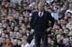 Arsenal's manager Arsene Wenger watches his team play from the technical area during the English Premier League soccer match between Tottenham Hotspur and Arsenal at White Hart Lane stadium in London, Sunday, March 16, 2014. (AP Photo/Matt Dunham)
