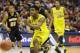 Michigan guard Derrick Walton Jr. (10) drives the ball during the second half of a second round NCAA college basketball tournament game against the Wofford Thursday, March 20, 2014, in Milwaukee. (AP Photo/Jeffrey Phelps)