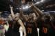 Mercer guard Langston Hall (21) and other Mercer players celebrate after the second half of an NCAA college basketball second-round game against Duke, Friday, March 21, 2014, in Raleigh, N.C. Mercer won 78-71. (AP Photo/Chuck Burton)