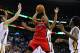 Toronto Raptors guard Kyle Lowry (7) drives to the basket against New Orleans Pelicans center Jeff Withey, left, and New Orleans Pelicans forward Al-Farouq Aminu, right, during the first half of an NBA basketball game in New Orleans, Wednesday, March 19, 2014. The Raptors won 107-100. (AP Photo/Jonathan Bachman)