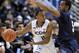 Connecticut's Ryan Boatright, left, is guarded by Villanova's Tony Chennault during the first half of an NCAA college basketball game in Hartford, Conn., Saturday, Feb. 16, 2013. (AP Photo/Fred Beckham)