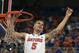 Florida guard Scottie Wilbekin (5) holds up a piece of the net after the Gators became the first team in Southeastern Conference history to go 18-0 in league pla, Saturday, March 8, 2014 in Gainesville, Fla. Florida defeated Kentucky 84-65 Saturday in an NCAA college basketball game. (AP Photo/Phil Sandlin)