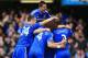 LONDON, ENGLAND - MARCH 22: Eden Hazard of Chelsea is mobbed by team mates after scoring their fourth goal from the penalty spot during the Barclays Premier League match between Chelsea and Arsenal at Stamford Bridge on March 22, 2014 in London, England. (Photo by Richard Heathcote/Getty Images)