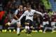 Manchester United's Wayne Rooney, right, scores from 45 yards out against West Ham United during their English Premier League soccer match at Upton Park, London, Saturday, March 22, 2014. (AP Photo/Sang Tan)