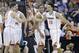 Virginia forward Anthony Gill (13) shakes hands with Virginia guard Joe Harris (12) during the second half of an NCAA college basketball second-round tournament game, Friday, March 21, 2014, in Raleigh. (AP Photo/Gerry Broome)