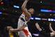 Washington Wizards guard Bradley Beal, right, puts up a shot as Los Angeles Lakers forward Nick Young defends during the second half of an NBA basketball game, Friday, March 21, 2014, in Los Angeles. The Wizards won 117-107. (AP Photo/Mark J. Terrill)