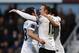 Manchester United's Wayne Rooney, center, celebrates his second goal against West Ham United with teammates during their English Premier League soccer match at Upton Park, London, Saturday, March 22, 2014. (AP Photo/Sang Tan)