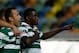 Sporting's William Carvalho, right, celebrates after scoring the opening goal against Pacos de Ferreira during their Portuguese league soccer match Sunday, Dec. 1, 2013, at Sporting's Alvalade stadium in Lisbon. (AP Photo/Armando Franca)