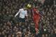 Tottenham's Nacer Chadli, left, heads the ball with Liverpool's Glen Johnson during their English Premier League soccer match between Tottenham Hotspur and Liverpool at the White Hart Lane stadium in London Sunday, Dec 15, 2013. (AP Photo/Alastair Grant)