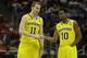 Michigan guards Nik Stauskas (11) and Derrick Walton Jr. (10) talk during the second half of a third-round game of the NCAA college basketball tournament Saturday, March 22, 2014, in Milwaukee. (AP Photo/Jeffrey Phelps)