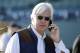 Trainer Bob Baffert talks on a cell phone while watching horses work out in preparation for this weekend's Breeders' Cup horse races at Santa Anita Park on Wednesday, Oct. 30, 2013, in Arcadia, Calif. (AP Photo/Jae C. Hong)