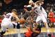 Toronto Raptors guard DeMar DeRozan, center, tries to control the rebound in front of Atlanta Hawks guard Kyle Korver (26) and Atlanta Hawks center Pero Antic (6) in the second half of their NBA basketball game Tuesday, March 18, 2014, in Atlanta. Atlanta won 118-113 in overtime. (AP Photo/David Tulis)