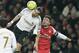 Arsenal's Olivier Giroud, right, challenges Swansea City's Chico Flores during their English FA Cup replay soccer match at Arsenal's Emirates stadium in London, Wednesday, Jan. 16, 2013. (AP Photo/Alastair Grant)