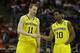 Michigan guards Nik Stauskas (11) and Derrick Walton Jr. (10) talk during the second half of a third-round game of the NCAA college basketball tournament Saturday, March 22, 2014, in Milwaukee. (AP Photo/Jeffrey Phelps)