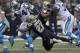 Carolina Panthers running back DeAngelo Williams (34) carries as New Orleans Saints free safety Malcolm Jenkins (27) tackles in the first half of an NFL football game in New Orleans, Sunday, Dec. 8, 2013. (AP Photo/Dave Martin)